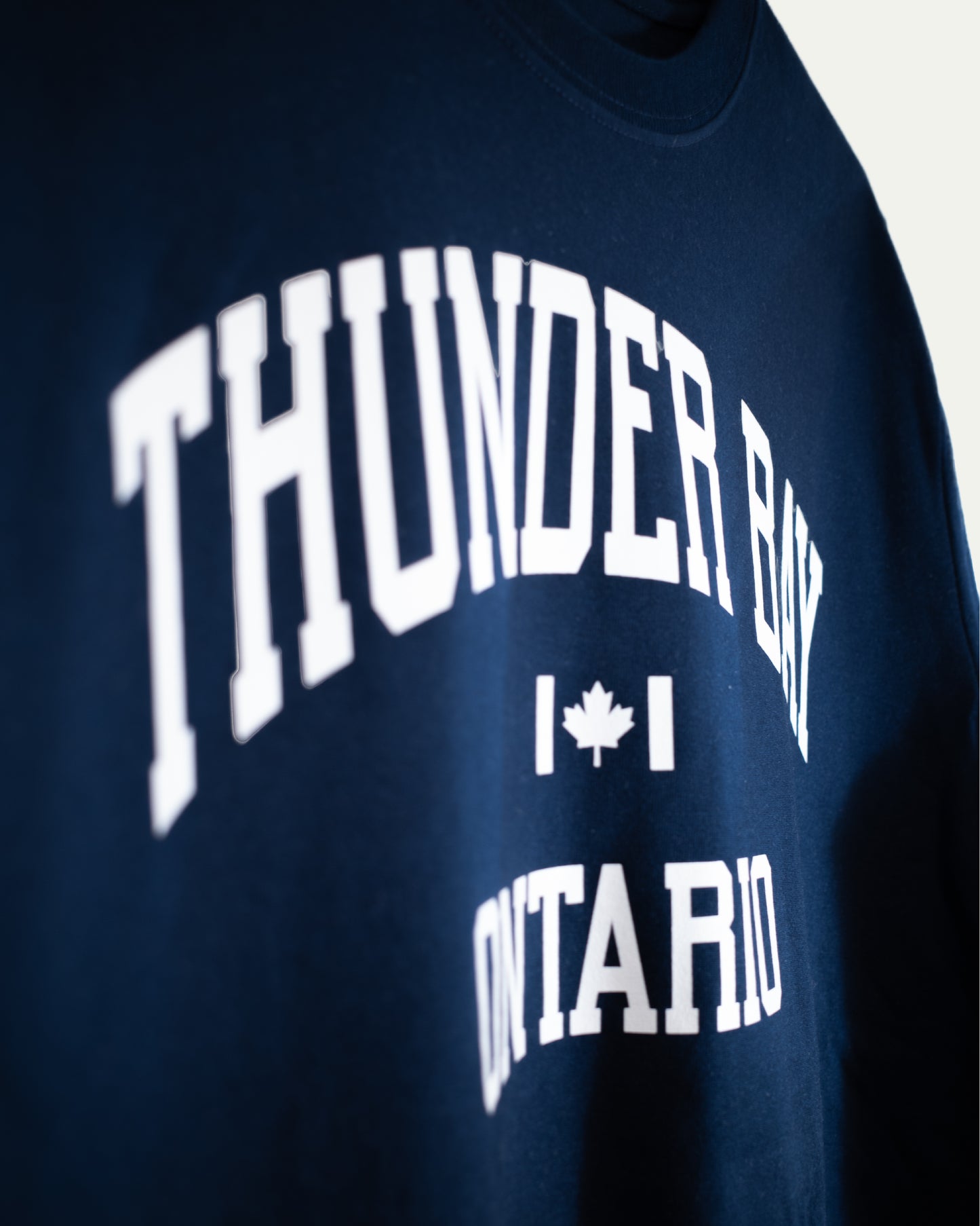 Navy blue sweatshirt with 'Thunder Bay Ontario' text and a maple leaf graphic.