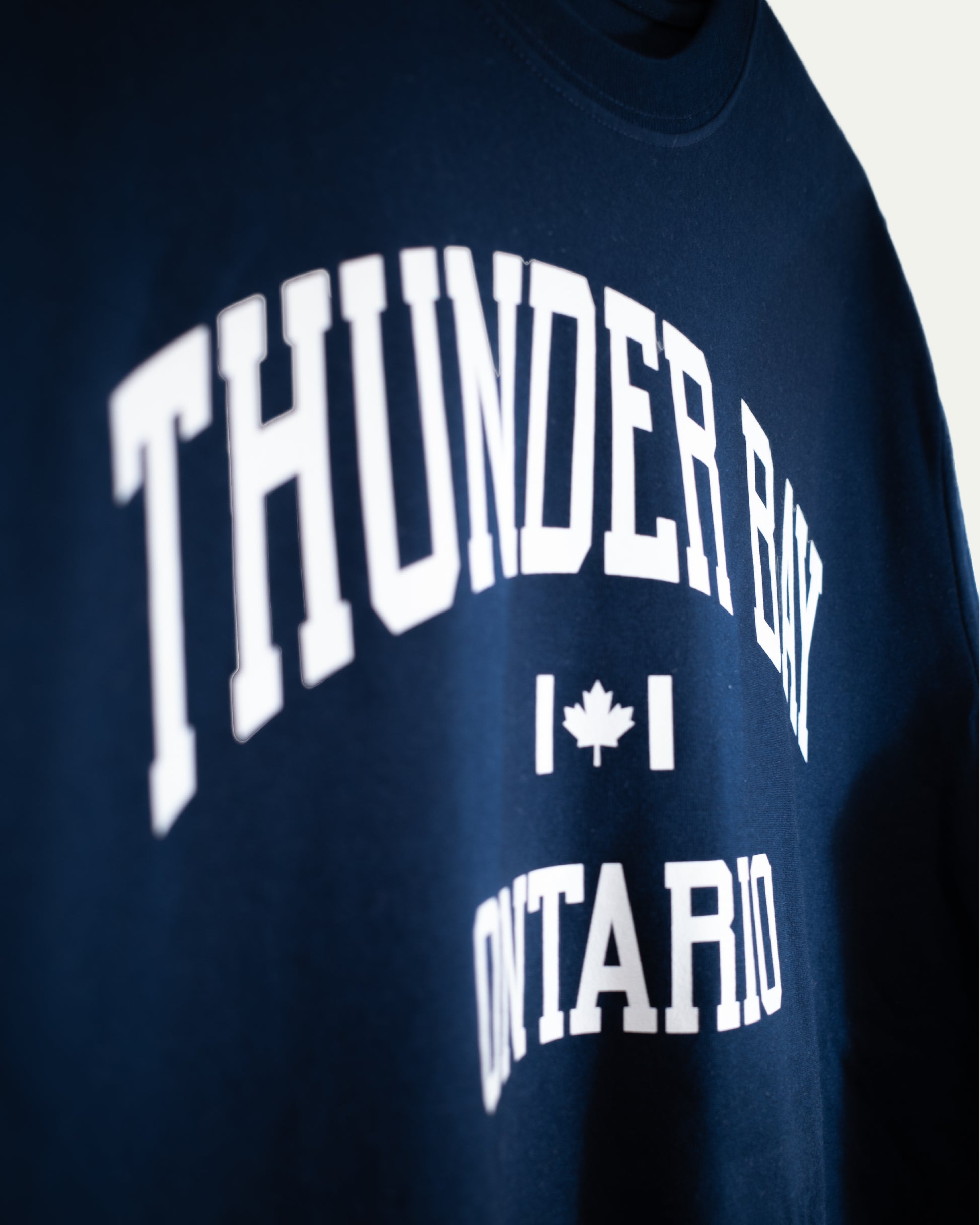 Navy blue sweatshirt with 'Thunder Bay Ontario' text and a maple leaf graphic.